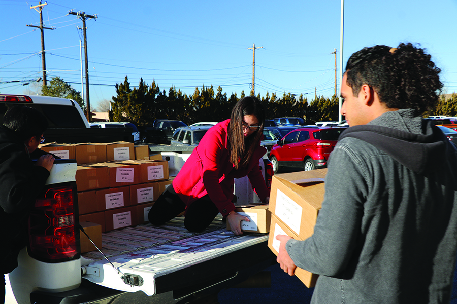 students unloading boxes of dictionaries