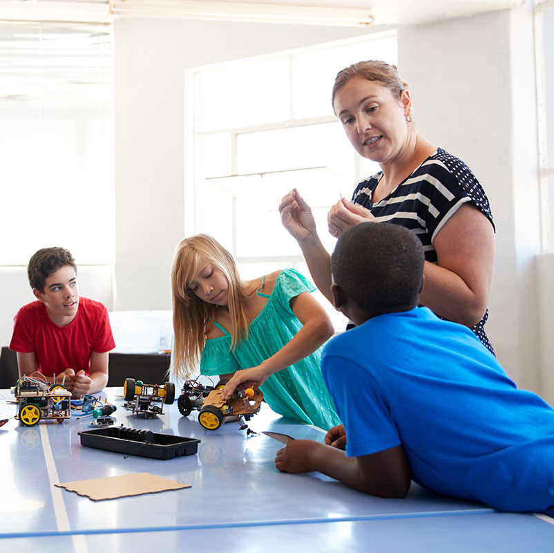 Teacher instructing STEM students.