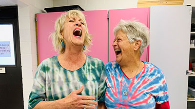 Two Encore students laughing in the West Classroom Complex at SJC Main Campus.