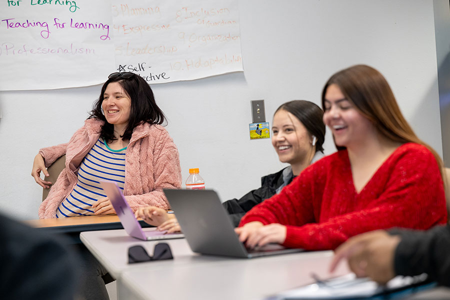 Students engaged in a lively classroom discussion at a community college, showing how community colleges work by offering supportive, interactive learning environments that differ from large university lecture halls.