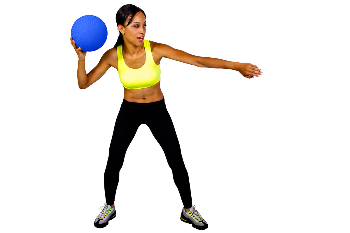 Girl holding a dodgeball about to throw
