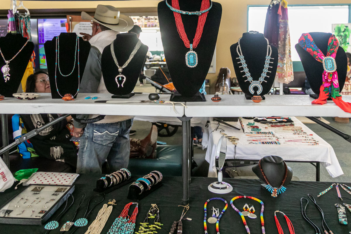 A collection of Native jewelry in red, turquoise, and natural stones.