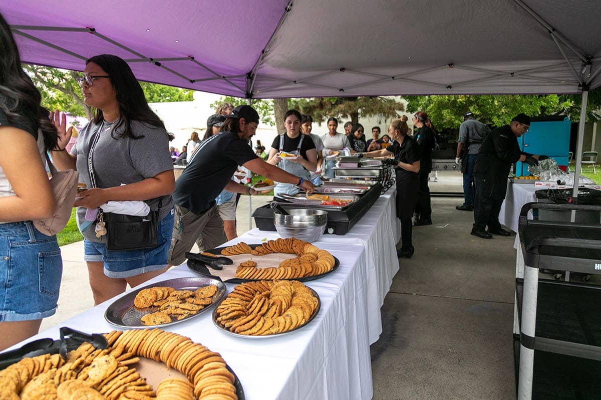 Group of SJC Students going through the line for dinner and cookies