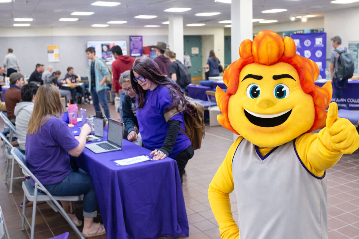 Blaze standing in front of a group of San Juan College students at a Resource Fair.
