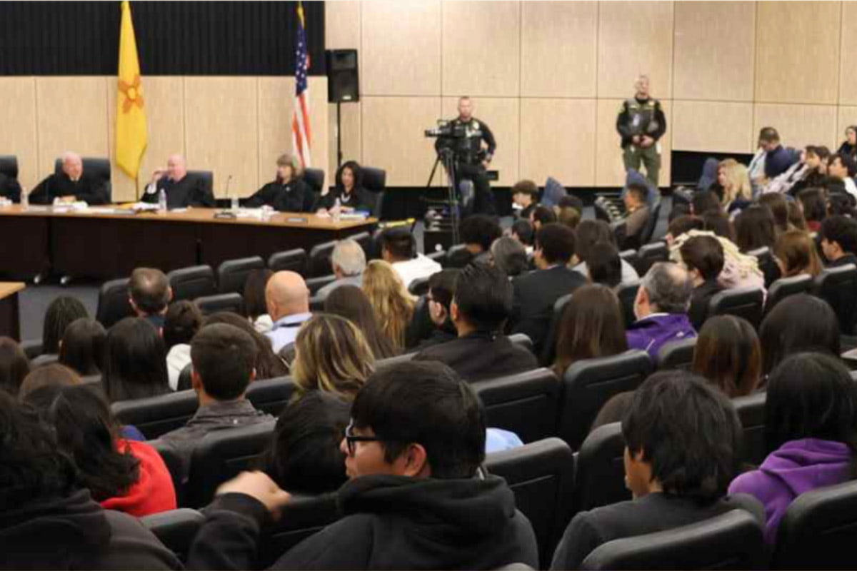 Group of people sitting in rows listening to the NM Supreme Court