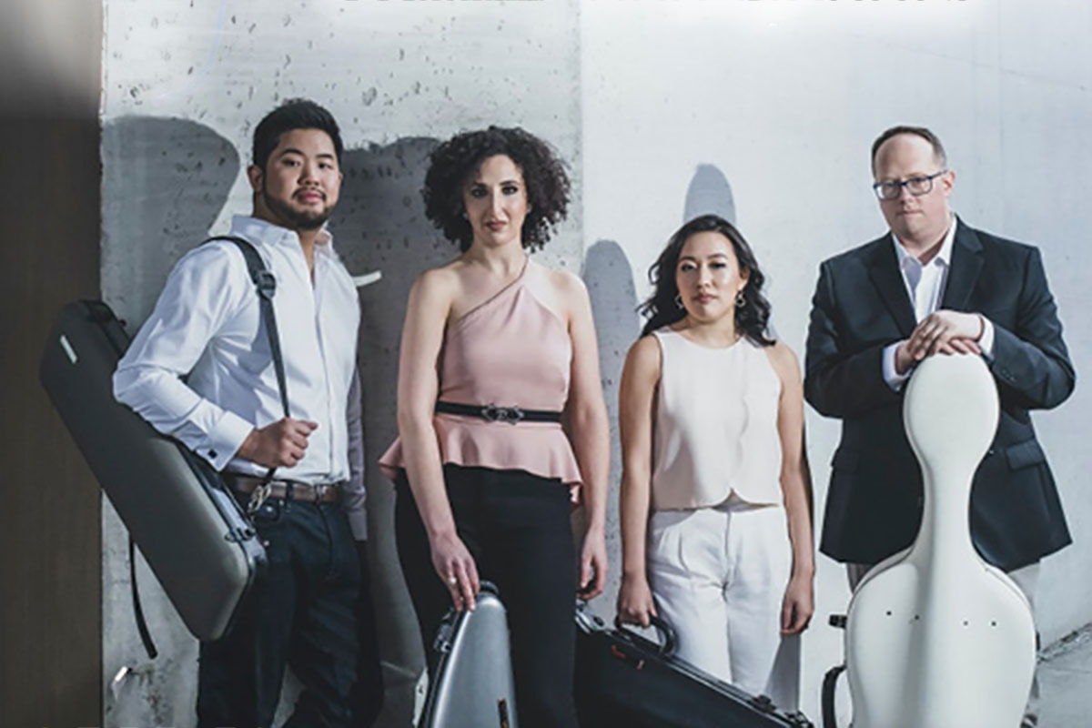 The Verona Quarter standing against a wall with their instruments in cases