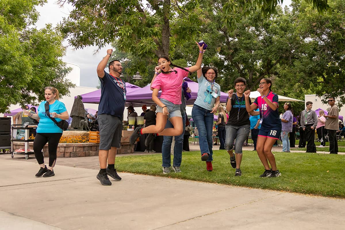 Group of SJC students jumping in the air at the Welcome Back party on main campus