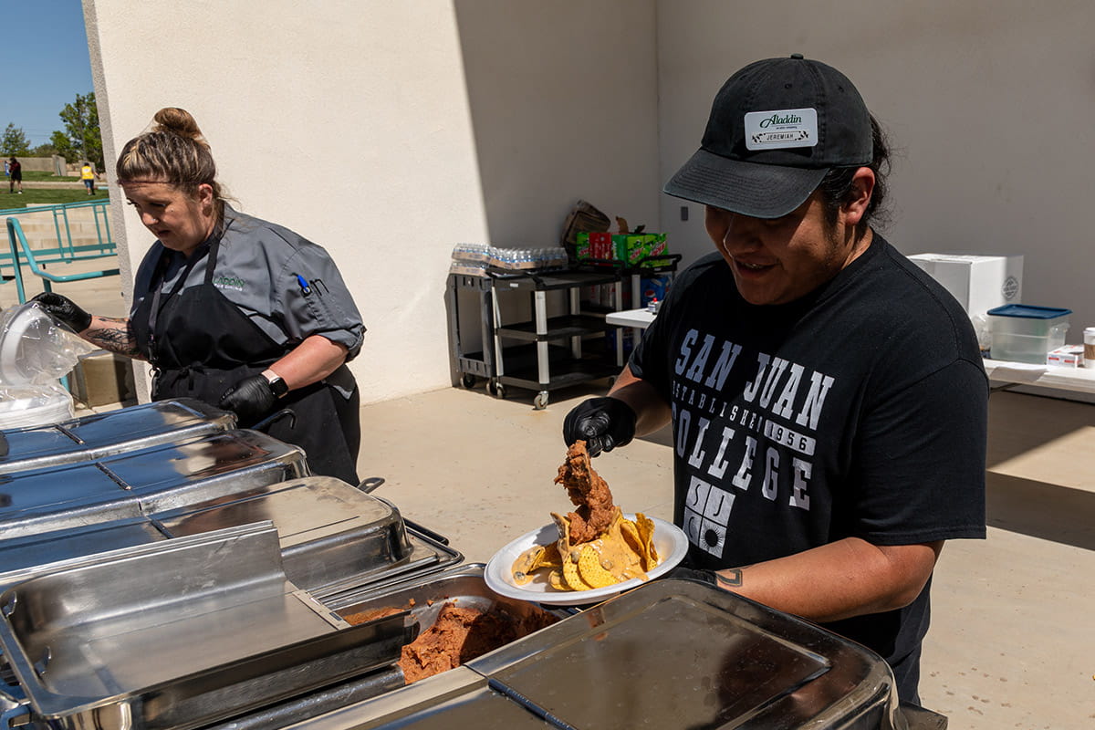 Two SJC employees serving at the Welcome Bash in the SJC Graduation Plaza.
