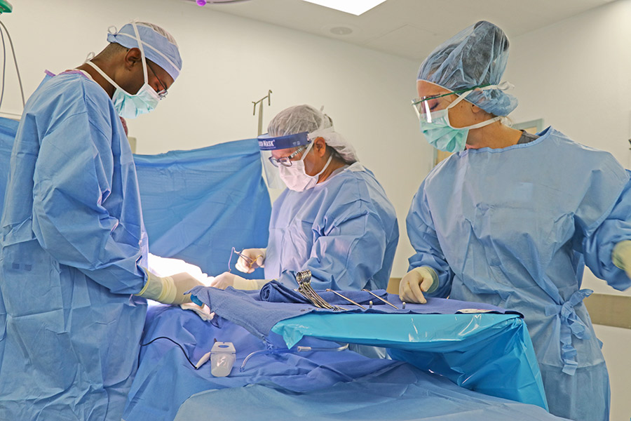 Student Surgical Technician works in simulated surgery in one of the operating room suites in the Health Science Simulation Center