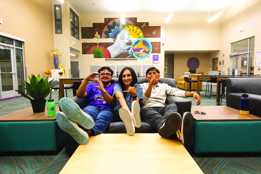 Three students sitting on couch in housing