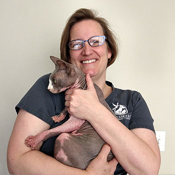 Iris Nigrin holding a hairless cat.