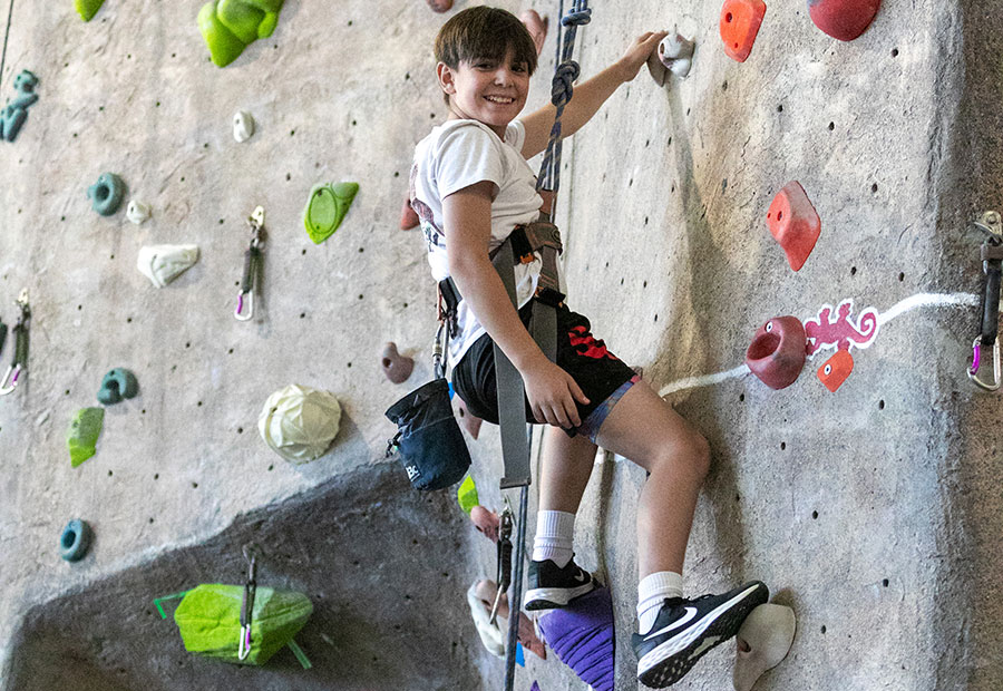 Kid on the HHPC Rock Climbing wall at SJC during Kids Kollege
