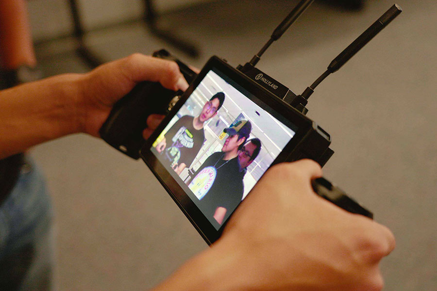 Students on a film set using equipment