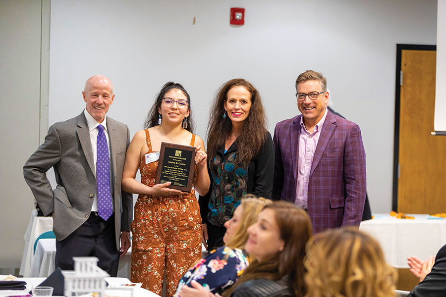 The Merrion Scholar of the Year, Analea Castro (holding the plaque), is pictured with T. Greg Merrion on left, President Dr. Toni Hopper Pendergrass and Board of Trustees member John Thompson.