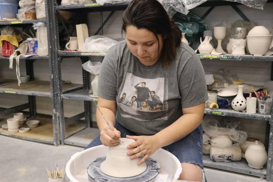 Student working on pottery wheel