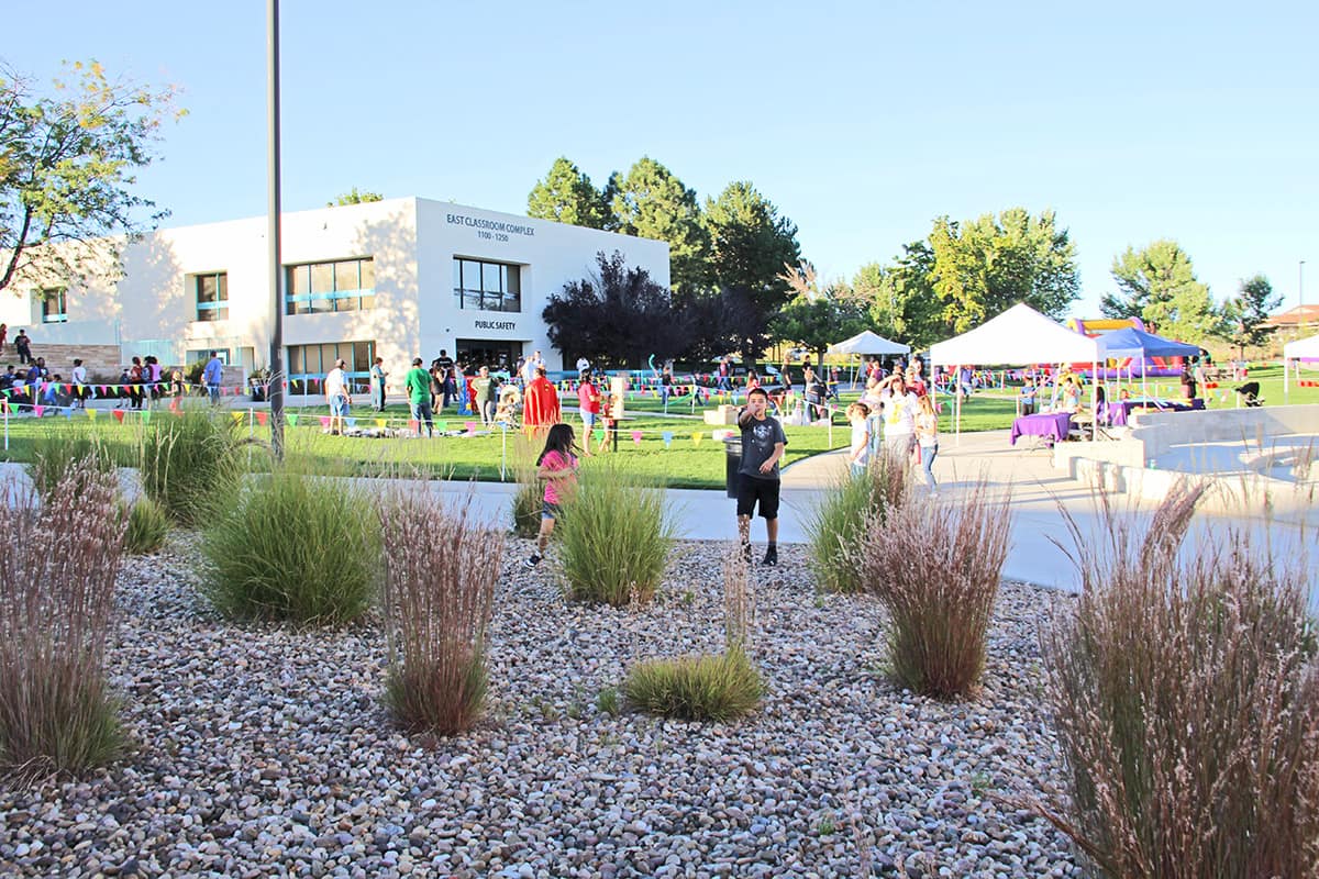 Families enjoy games on the lawn at Learning Commons Plaza.