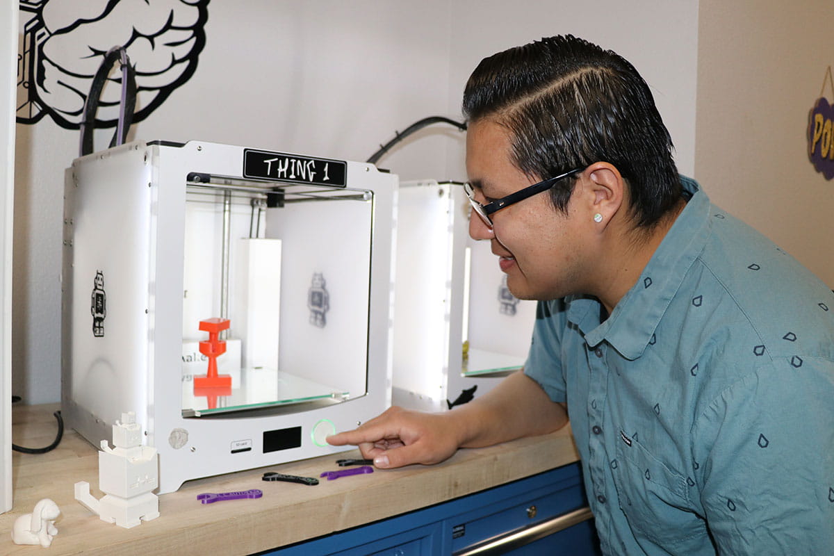 SJC Student working with a 3-D printer