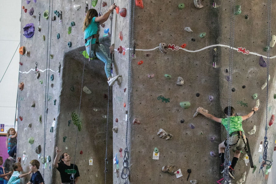 Three Kids Kollege students climbing on the Indoor Rock Climbing wall at HHPC