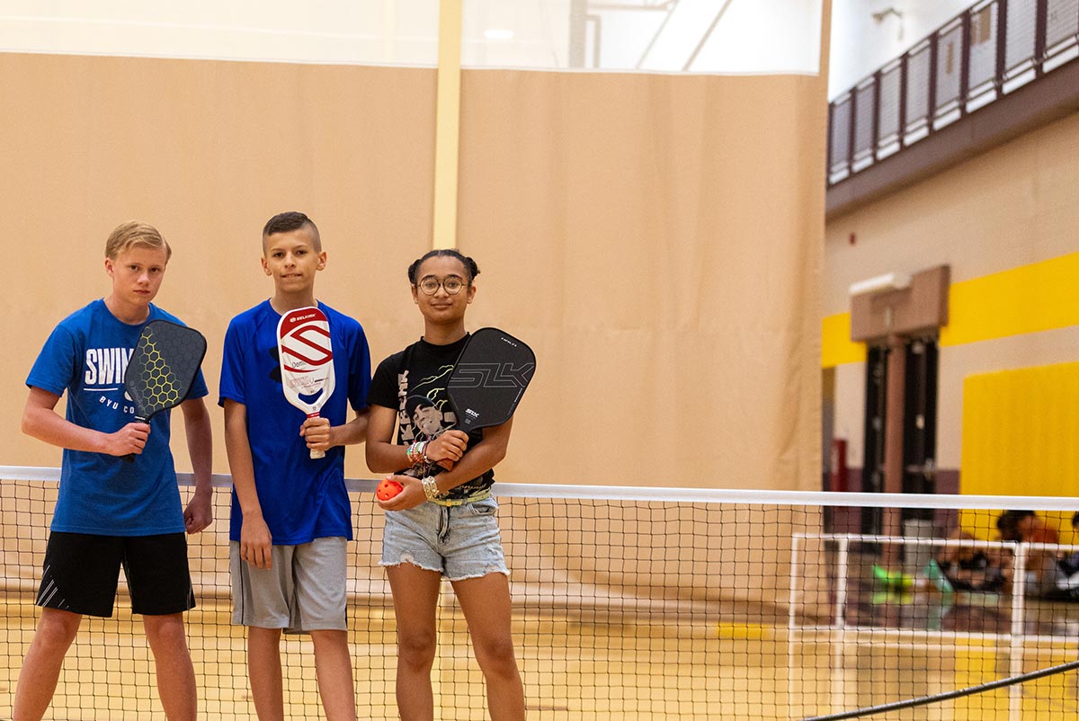 Kids Kollege students on the pickleball court holding their paddles