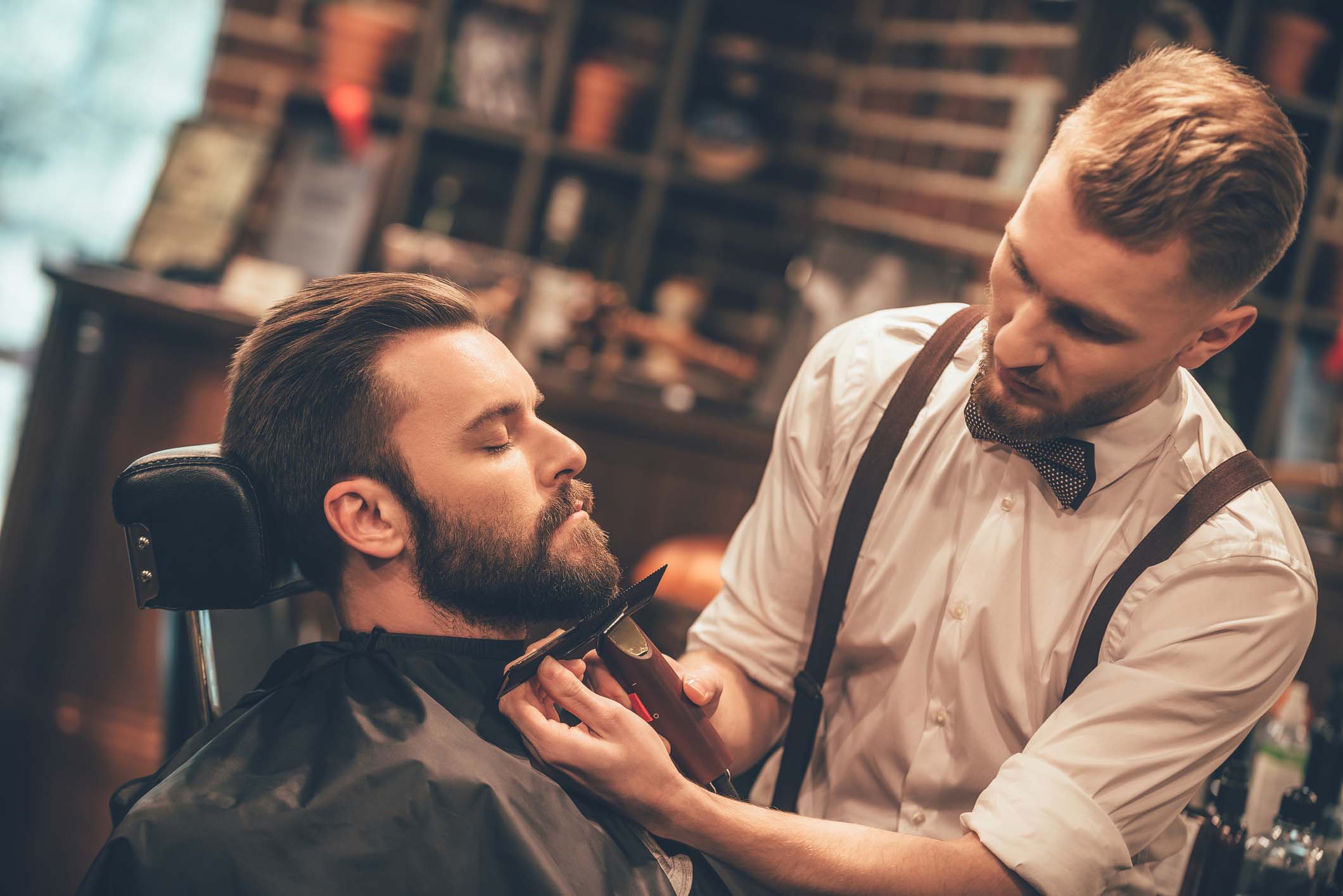 Gentleman with a barber getting a beard trim