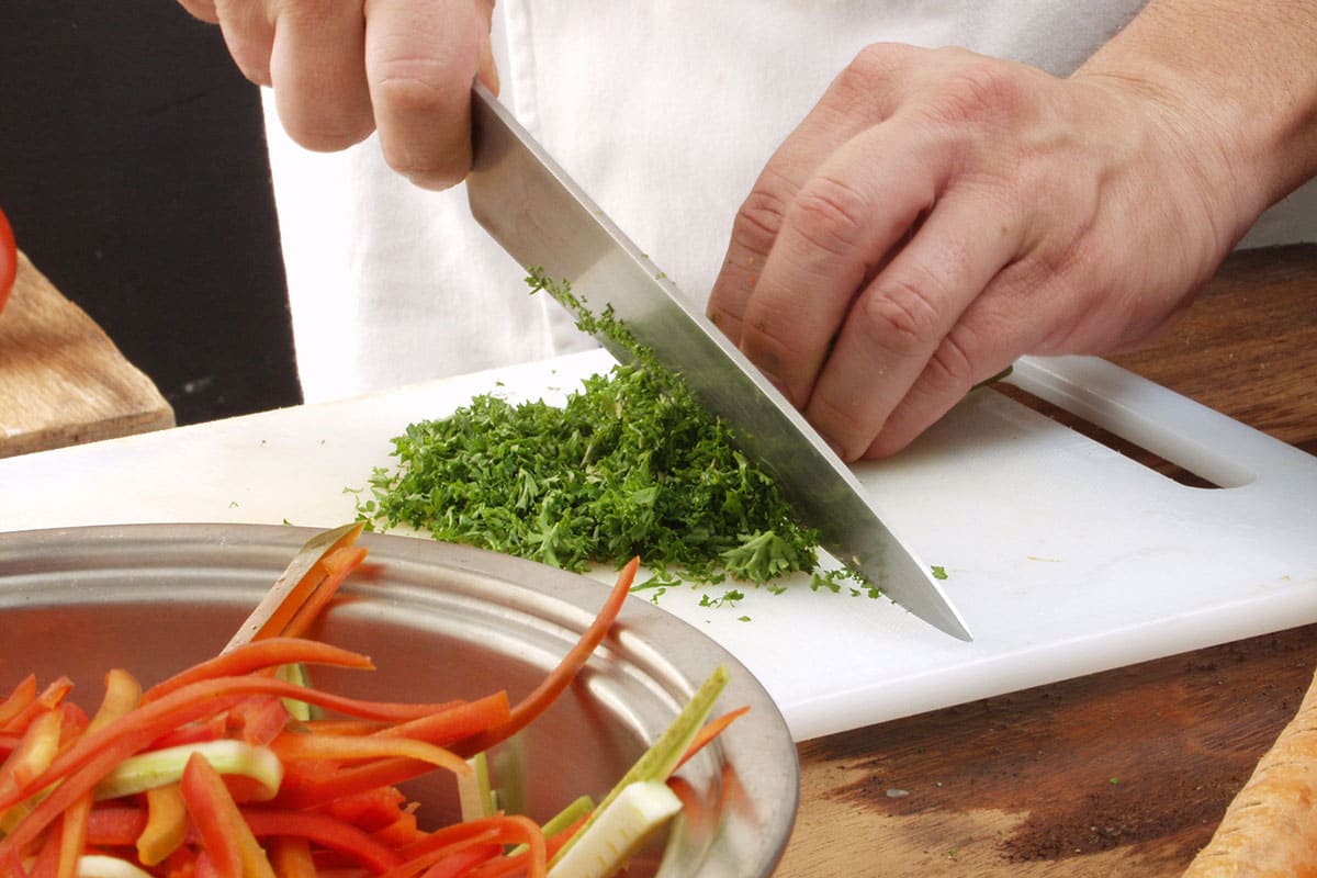 basic knife skills student chopping herbs
