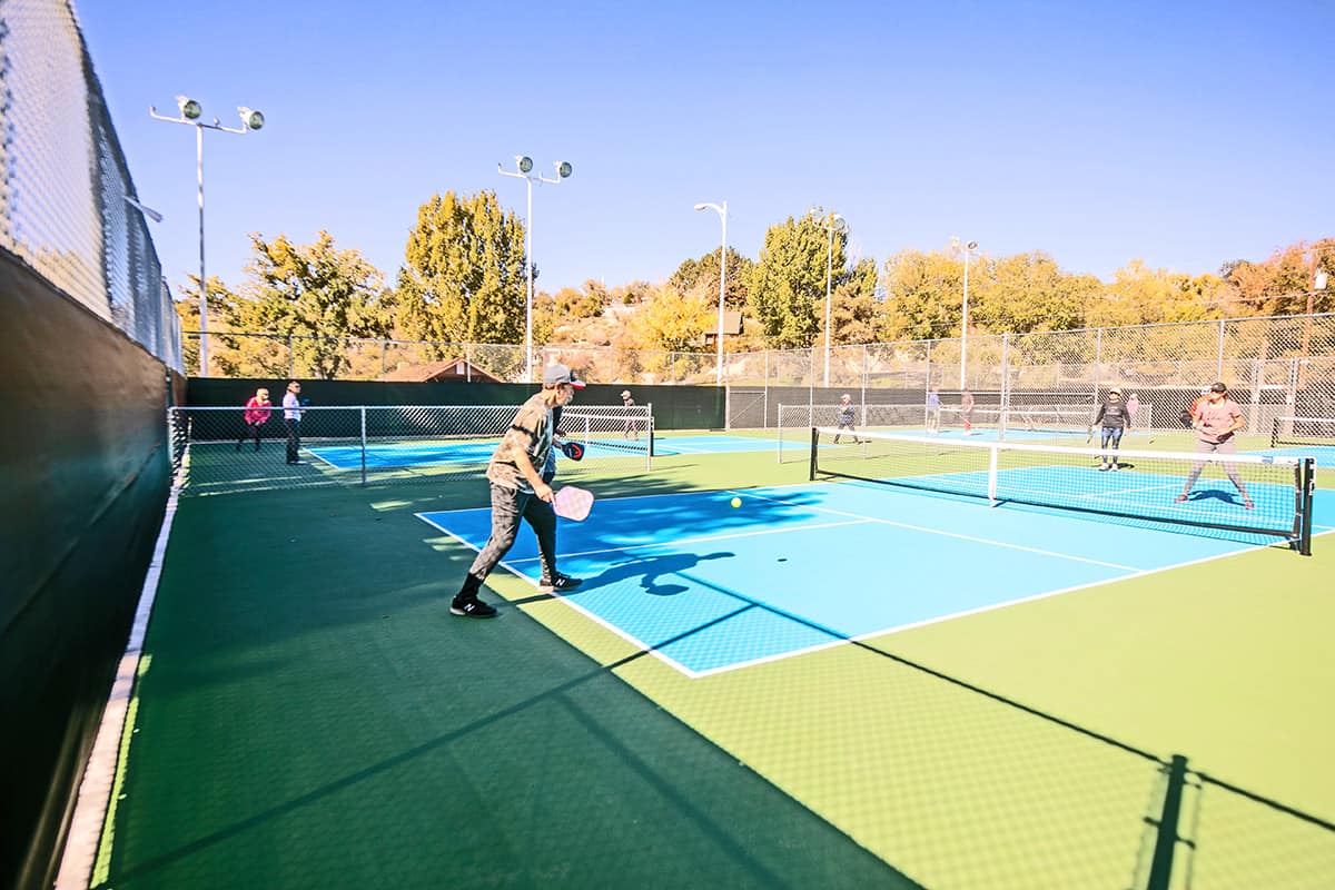 Seniors enjoy playing pickleball on a bright fall day at Brookside park.