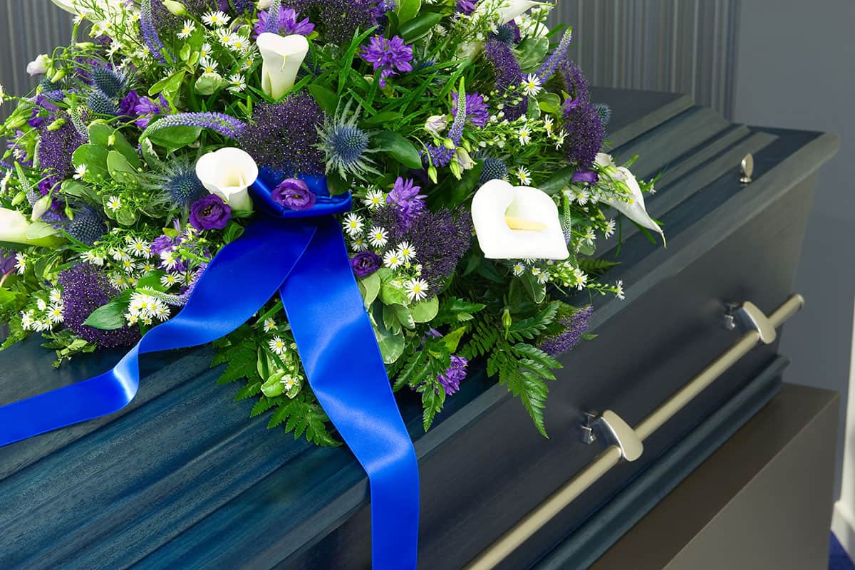 Flowers laying atop a casket.