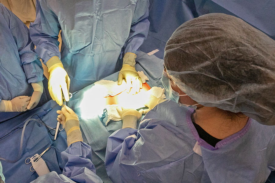 An overhead view of surgeons working on a patient