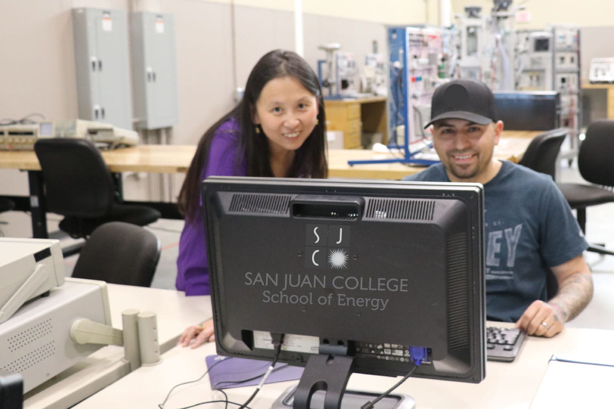 Two people looking at SJC School of Energy computer