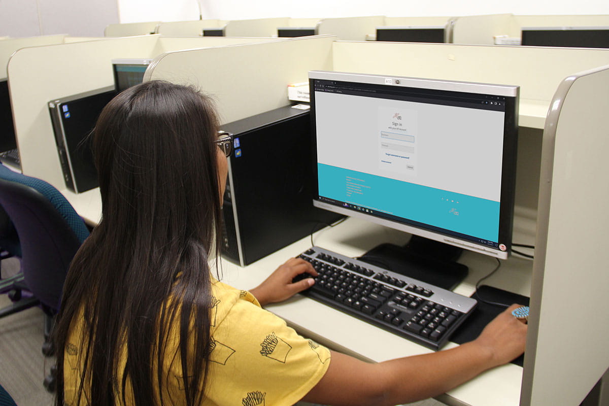 Young woman sits at computer in the testing center.