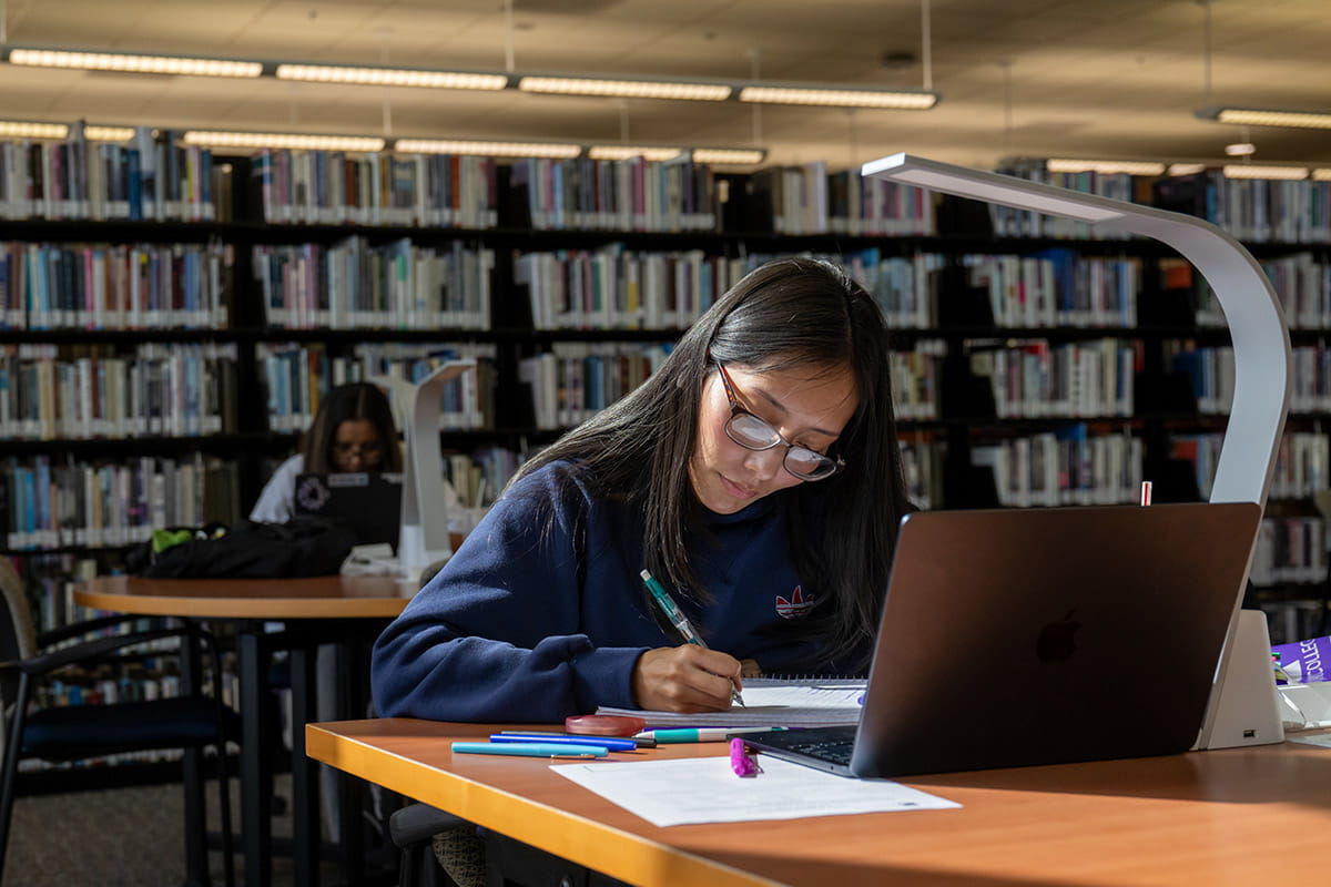 A San Juan College Student studying in the Library on main campus