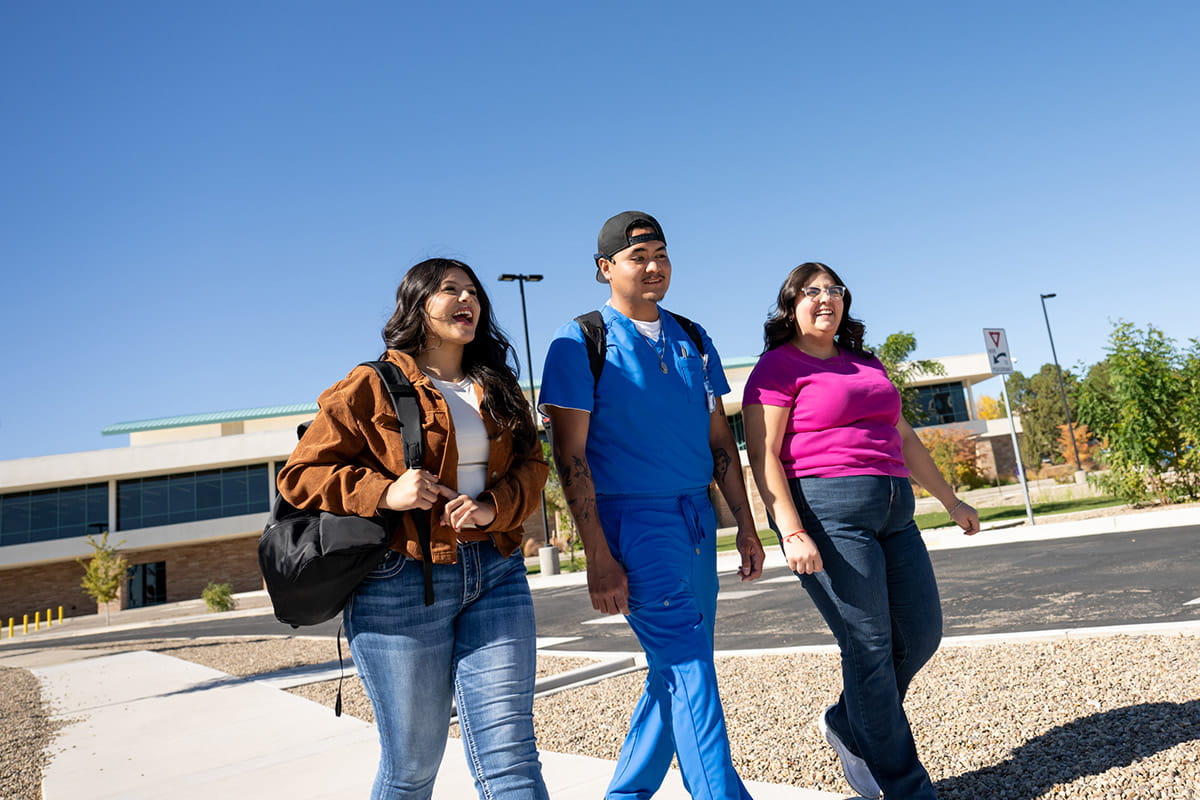 Three SJC students walking on main campus
